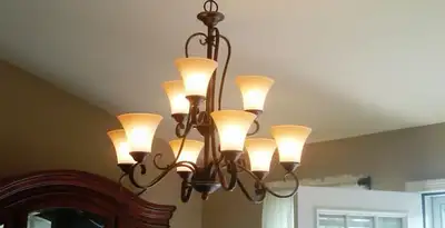 Classic ceiling chandelier installation with warm lighting in Raleigh, NC