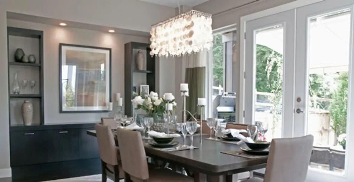 Elegant dining room chandelier installation above table in Raleigh, NC