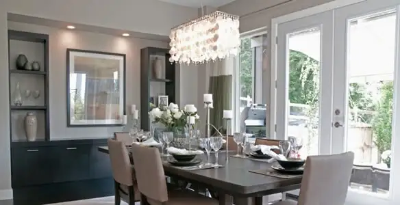 Elegant dining room chandelier installation above table in Raleigh, NC