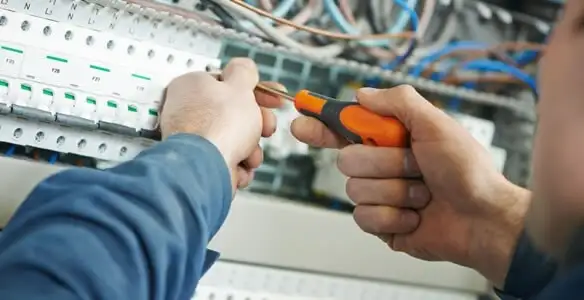 electrical service showing licensed electrician performing electrical panel maintenance and adjustments in Raleigh, NC