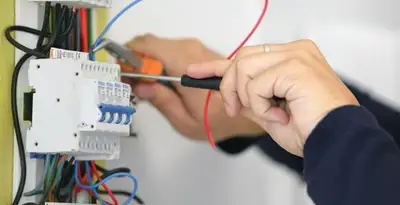 Electrician installing and adjusting circuit breakers in an electrical panel in Raleigh, NC