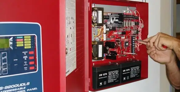fire alarm installation service showing technician configuring fire alarm control panel in Raleigh, NC