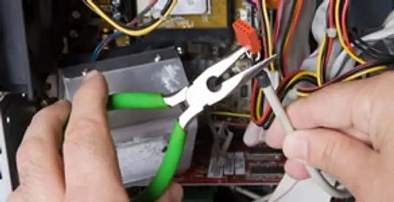 Licensed electrical contractor performing electrical repair with tools in Morrisville, NC