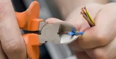 professional electrical services showing precise wire cutting by licensed electricians in Raleigh, NC