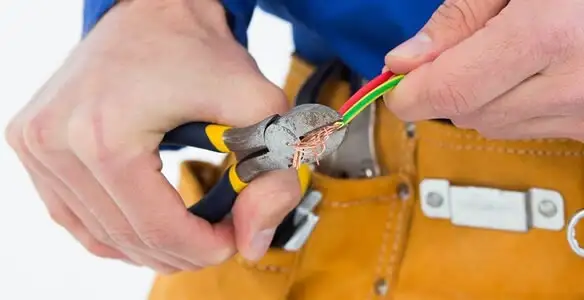 licensed electrician securing electrical wiring with professional tools during service work in Raleigh, NC