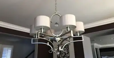 Modern chandelier installation with multiple light fixtures in Raleigh, NC