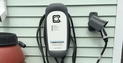 Outdoor electric vehicle charger installation on residential wall in Raleigh, NC