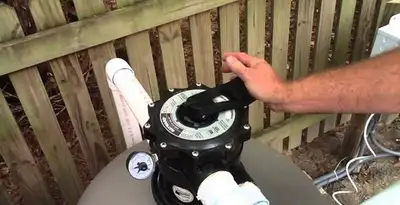 pool pumps service showing professional adjustment of pool pump control system in Raleigh, NC
