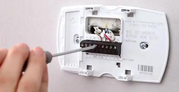 Thermostat installation service with proper wiring and secure wall mounting in Raleigh, NC