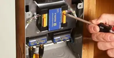 Whole home surge protection device being installed by a licensed electrician to protect electrical systems in Raleigh, NC